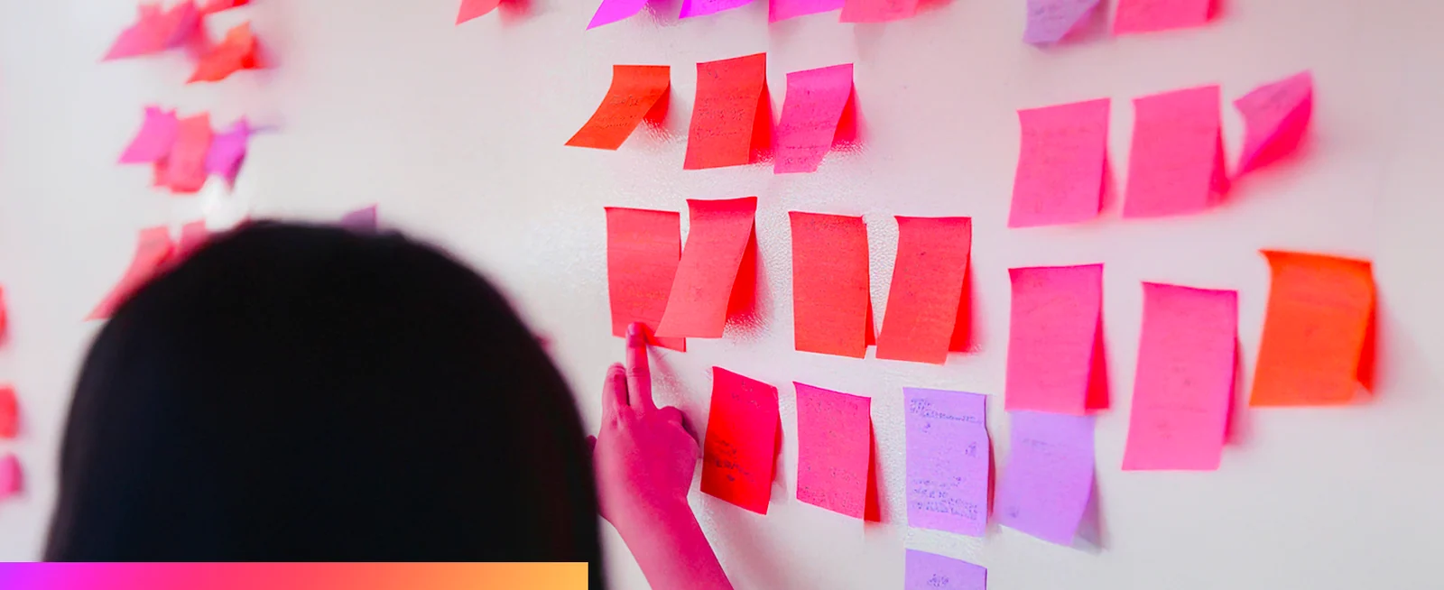 Sticky notes grouped on a wall during a workshop